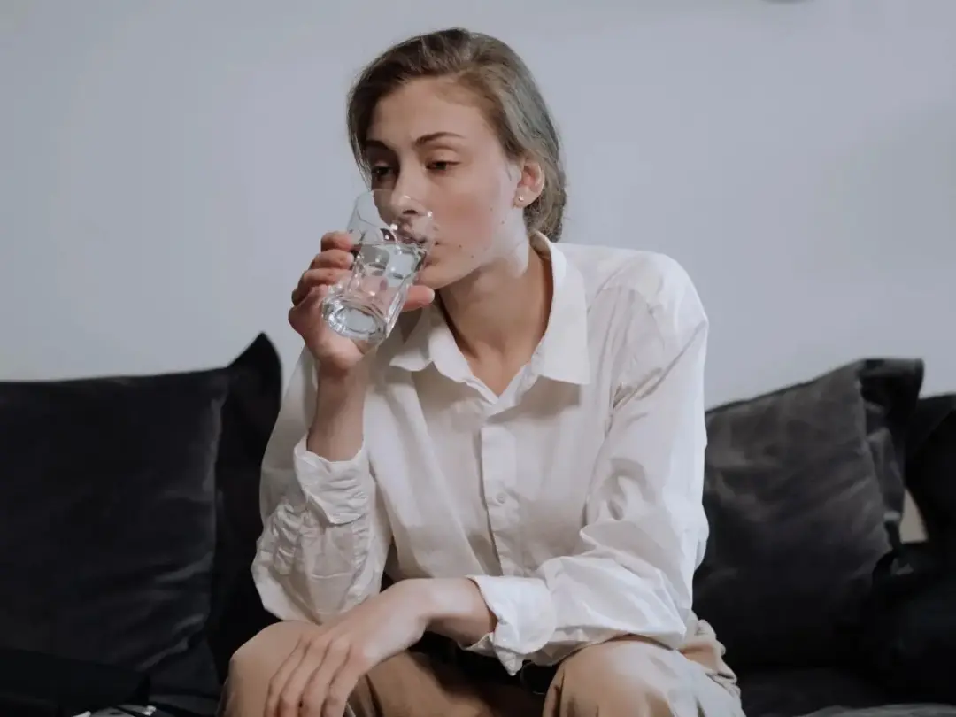 Woman drinking water to stay cool and hydrated